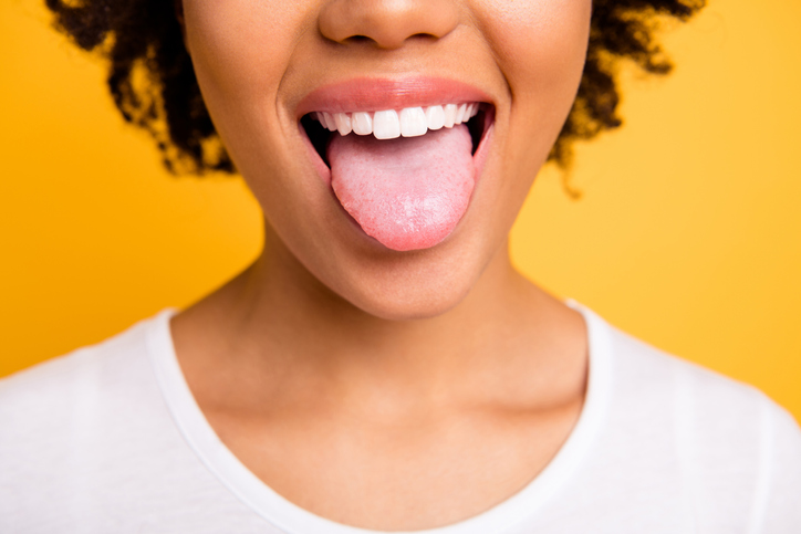 The image features a person wearing a white shirt against a bright yellow background, with only their neck and part of the shoulder visible. The contrast between the white shirt and vibrant yellow backdrop creates a striking visual effect